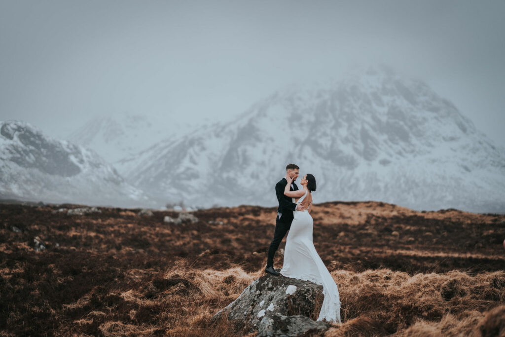 Couple posing in the scottish highlands during their elopement