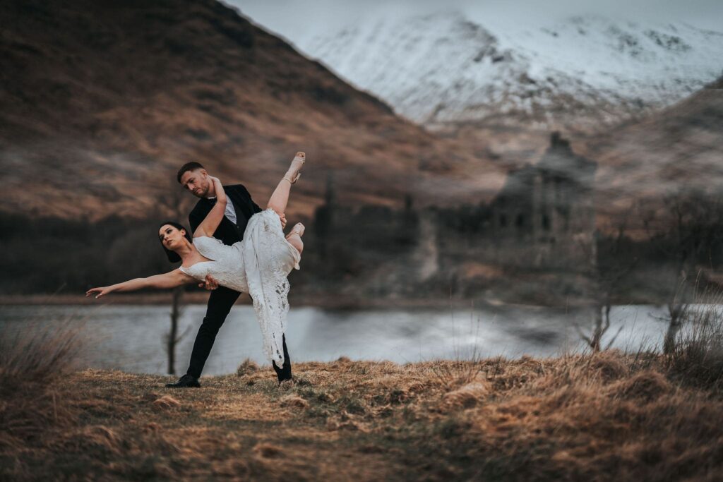 Couple in front of a castle in the scottish highlands